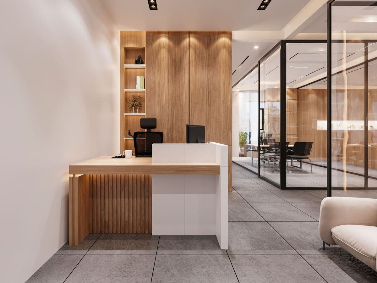 An uncluttered reception desk in a warm, wood-panelled interior.